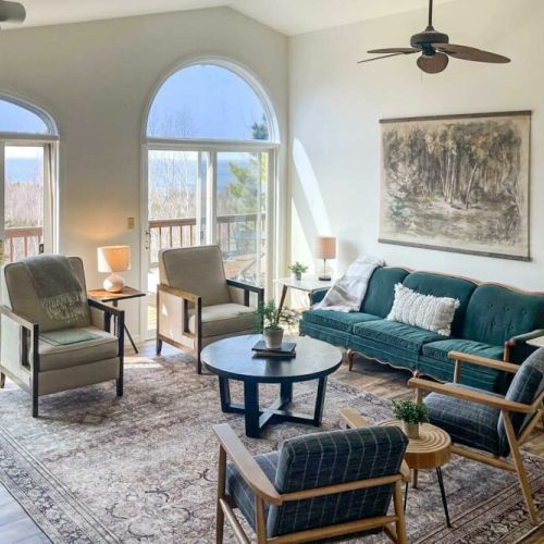The second living area off of dining room offers abundant space for the entire group to unwind comfortably. You can also relish the warmth of a second fireplace and step out onto the wrap-around deck for even more relaxation and enjoyment.