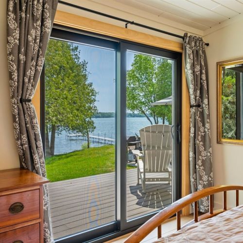 The primary bedroom has direct lake views and doors to our lakeside deck.
