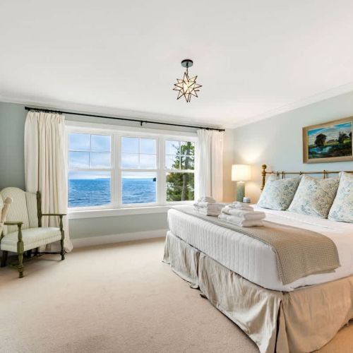 Upstairs, the master suite features a king bed with stunning bay views.