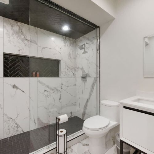 The luxury continues in the basement with a full bathroom featuring a spacious walk-in shower.