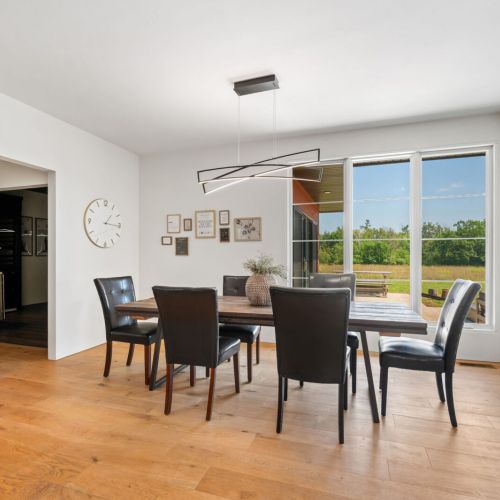 From the dining space, step into the dedicated entertaining wing—complete with a half bath, intimate movie theater with bar, and panoramic views of the prairie landscape.