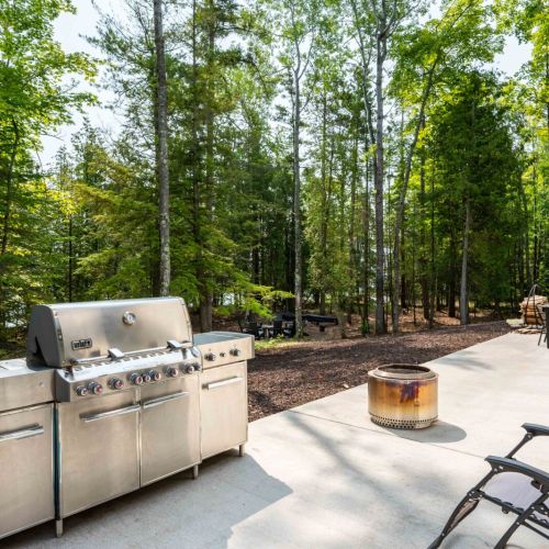 The expansive patio offers plenty of room for outdoor cooking and dining, complete with a premium grill that's perfect for crafting flavorful meals.