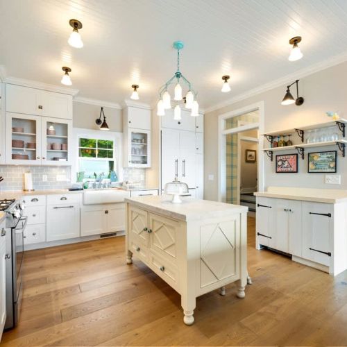 The fully equipped kitchen includes classic white cabinetry, butcher block counters, a drip coffee maker, and dishwasher—perfect for preparing meals together.