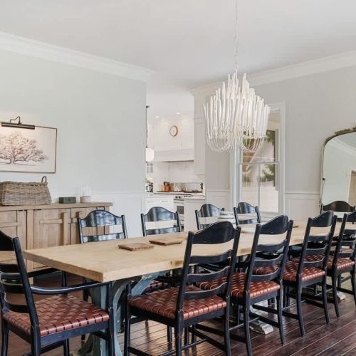 The large dining table offers an ideal spot to gather and share meals in a bright and comfortable setting.