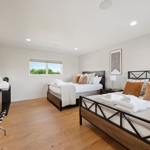 Upstairs bedroom #3 features two comfortable queen beds, Smart-TV and access to the jack-and-jill bathrooms.