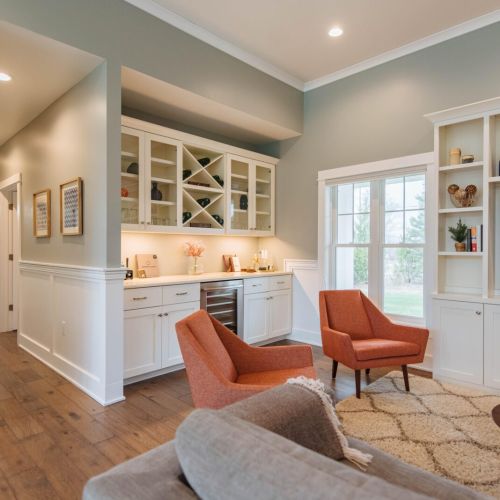 Sip, Relax, and Enjoy: Our dry bar and wine fridge, seamlessly integrated into the main living area, offer the perfect spot for entertaining or unwinding after a day exploring Door County. With ample storage for your favorite beverages and glassware, this elegant setup enhances your stay with convenience and style.