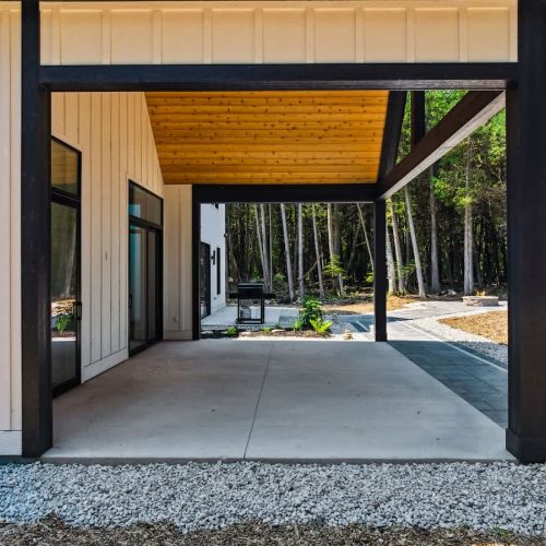 Outdoors, the expansive patio invites guests to relax under the trees, dine al fresco, or gather around the fire pit. With a barbecue grill, outdoor seating, and serene surroundings, it’s the perfect setting for reconnecting with friends and family.