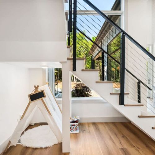 Tucked under the stair case, a kids tent and books for the smallest of travelers.