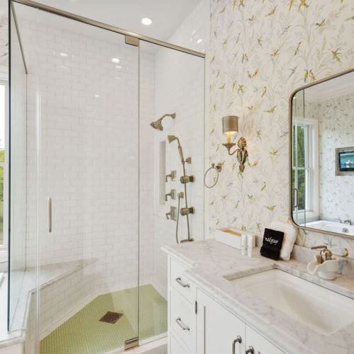 The master suite enhances the serene atmosphere, creating a spa-like oasis with a large soaking tub, a walk-in shower, and dual vanities offering ample space to get ready for the day.