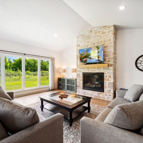 Relax in a clean and comfortable living area with peaceful orchard views just outside your window.