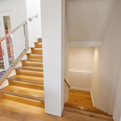 Heading downstairs to the basement level, you'll find an additional entertainment area, home-gym, full-bathroom, and final bedroom.