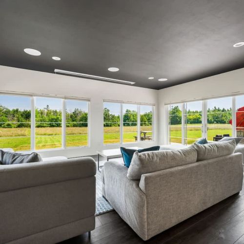 From the dining space, step into the dedicated entertaining wing—complete with a half bath, intimate movie theater with bar, and panoramic views of the prairie landscape.