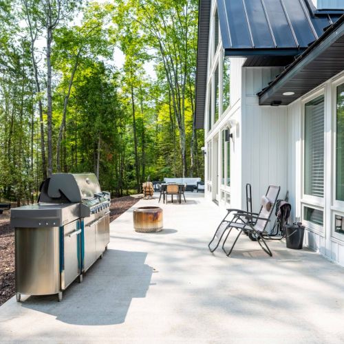 The expansive patio offers plenty of room for outdoor cooking and dining, complete with a premium grill that's perfect for crafting flavorful meals.