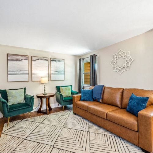 Unwind in the stylish additional living area featuring a comfortable leather sofa (queen sized sleeper), chic decor, and a large flat-screen TV. This cozy space is perfect for movie nights or quiet relaxation.