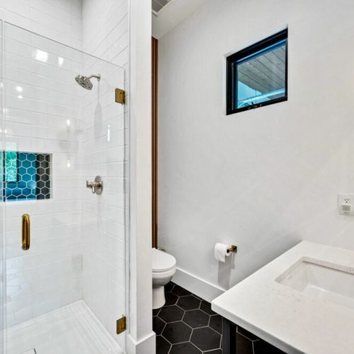 First floor bathroom offers an incredible walk in shower and newly renovated stylish design.