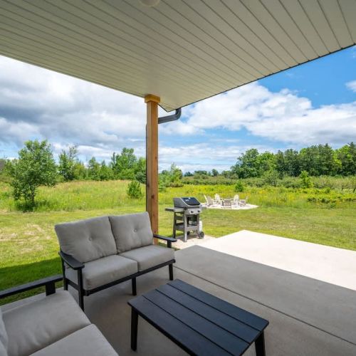 Step outside to the covered back patio, where orchard views set the scene for al fresco dining, grilling, or simply sipping wine as the sun sets.