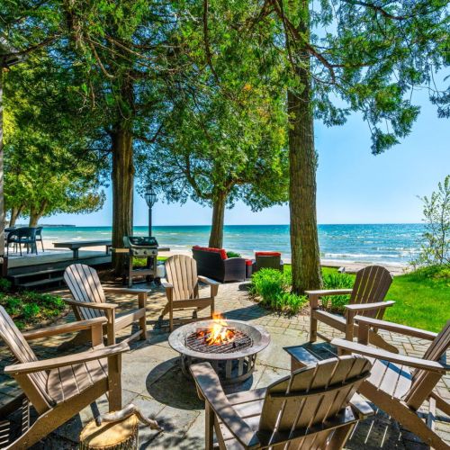 Encircled by Adirondack chairs, the outdoor first pit invites guests to enjoy balmy evenings under the stars, share stories, or simply relax to the rhythmic sounds of the waves. It's an idyllic end to any day spent exploring Door County.