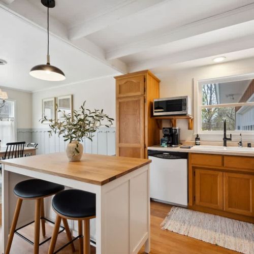 A sunny, fully equipped kitchen, featuring both a standard coffee maker and Keurig, dishwasher, microwave, toaster, and more-perfect for everything from morning pancakes to holiday dinners.