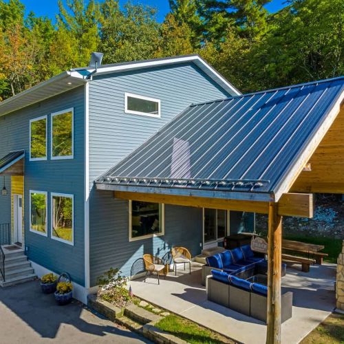 Relish the expansive outdoor living space, featuring a magnificent outdoor fireplace. Share laughter and stories under the starry night sky, enveloped by the tranquil forest setting.