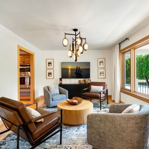 Indulge in pure relaxation and comfort as you sink into plush cushions, enveloped by natural light and the cozy ambiance of our sitting room.