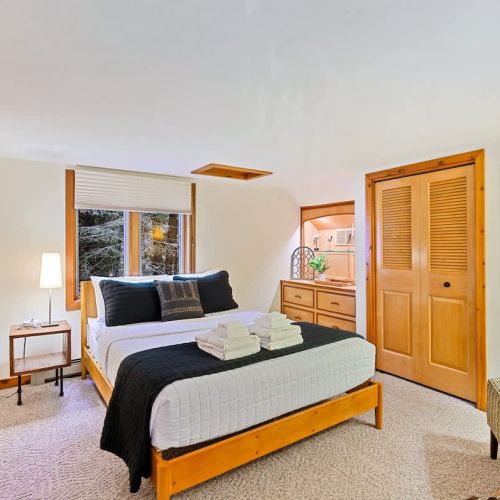 Retreat to this inviting upper-level bedroom, where the queen-sized bed awaits to envelop you in comfort. Dressed with luxurious linens from the Comphy Company, renowned for their quality and comfort, every detail has been thoughtfully considered.