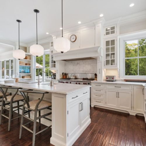 The fully equipped kitchen is a culinary dream, featuring modern appliances and ample counter space, perfect for preparing family meals or hosting gatherings.