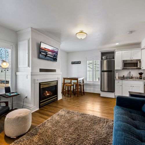 The living room features a gas fireplace and queen-sized sleeper sofa.