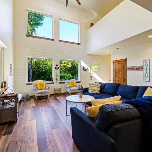 The main living area invites you to relish cozy comfort by the fireplace, with plenty of natural light and room to relax and entertain.