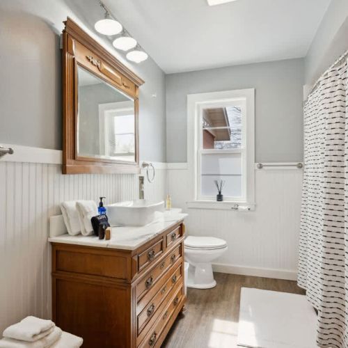 The bathrooms at Cherry Brick Cottage keep the home's classic style with updated finishes. The main floor has a full bathroom that's convenient for guests and family use.