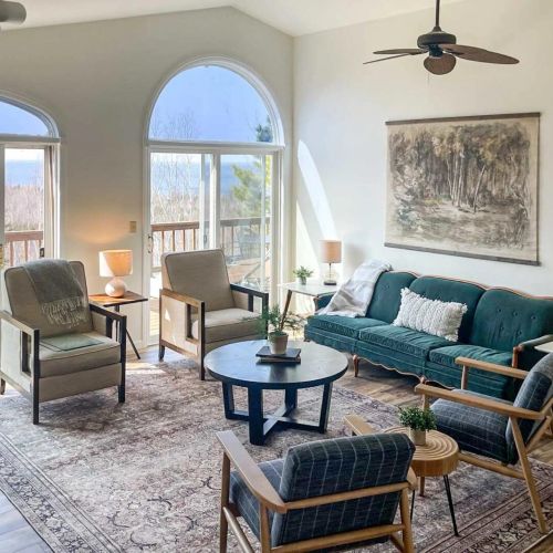 The second living area off of dining room offers abundant space for the entire group to unwind comfortably. You can also relish the warmth of a second fireplace and step out onto the wrap-around deck for even more relaxation and enjoyment.