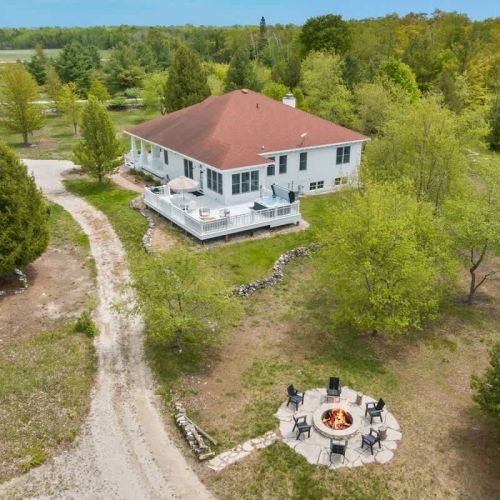 The fire pit invites you to gather around for s'mores and stories under the stars, while the hot tub provides a luxurious spot to unwind and soak in the tranquility of the dark sky region, ideal for stargazing and occasionally catching glimpses of th