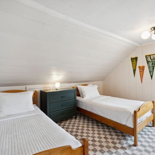 The second bedroom features two twin-sized single beds and smart tv-perfect for kids, teens, and those young at heart.