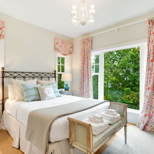 The first bedroom features a comfortable queen-sized bed and gorgeous water views.