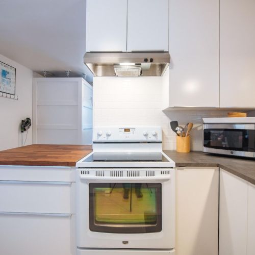 The kitchen includes an electric stove/oven.