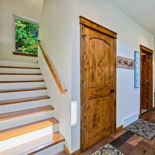 Staircase off the main living area leading up to 2 bedrooms and 2 bathrooms