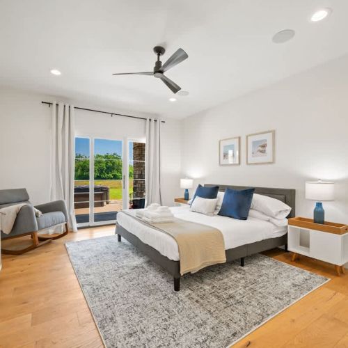 The main-floor primary suite offers a comfortable king bed and a serene, spa-inspired ensuite complete with a large walk-in shower.