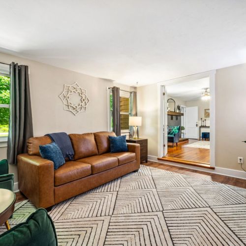 Unwind in the stylish additional living area featuring a comfortable leather sofa (queen sized sleeper), chic decor, and a large flat-screen TV. This cozy space is perfect for movie nights or quiet relaxation.