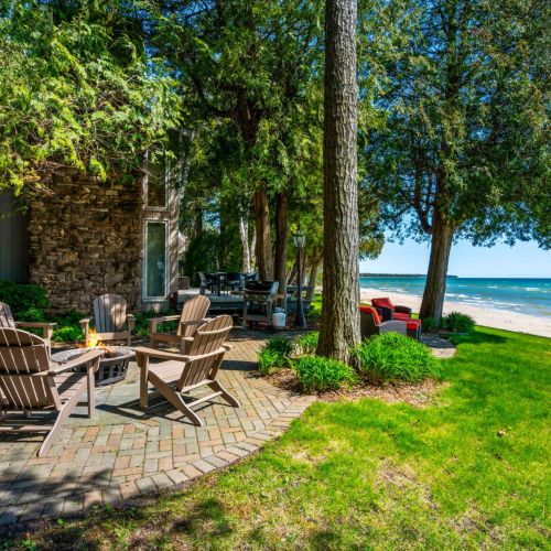 Outdoor fire pit overlooking with Adirondack chairs.