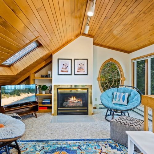 A gas fireplace adds a touch of warmth to this cozy nook, creating the perfect ambiance for delving into the diverse collection of books.