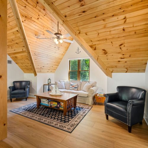 The loft provides an additional living space where guests can enjoy board games, relax with a book, or spend quality time together away from the main living area.