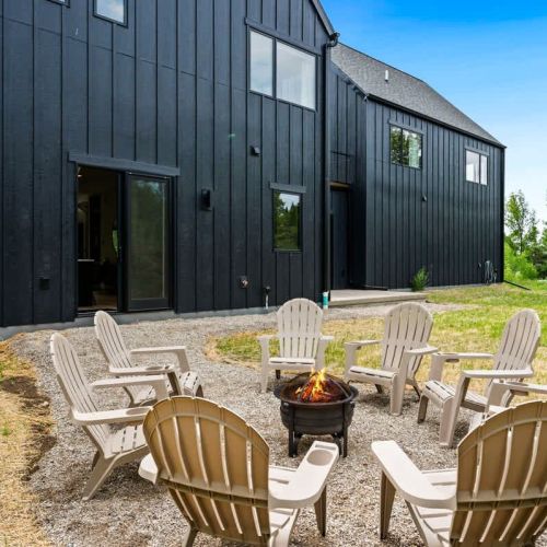 Indulge in the pleasure of an outdoor firepit, an ideal setting for creating cherished moments while delighting in the art of toasting marshmallows beneath the shimmering night sky.