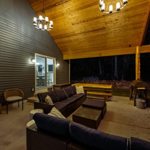 Relish the expansive outdoor living space, featuring a magnificent outdoor fireplace. Share laughter and stories under the starry night sky, enveloped by the tranquil forest setting.