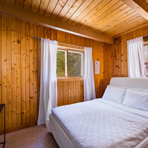 One of two bedrooms on the main floor, this one features a queen-sized bed and hotel-quality linens.