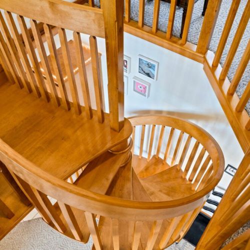 The beautiful spiral stair at the center of the home provides access to the upper level.  While it adds architectural character, guests with mobility concerns may prefer the bedroom on the main level.