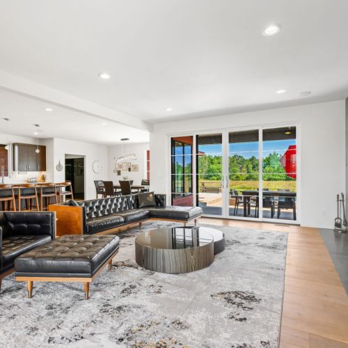 A spacious, modern open-concept living area brings everyone together, while a glowing fireplace and Smart TV create the perfect backdrop for relaxation and entertainment.