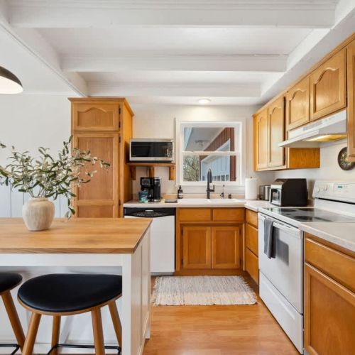 A sunny, fully equipped kitchen, featuring both a standard coffee maker and Keurig, dishwasher, microwave, toaster, and more-perfect for everything from morning pancakes to holiday dinners.