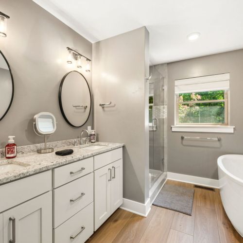 The first floor en-suite features a double vanity, walk-in shower and large soaker tub