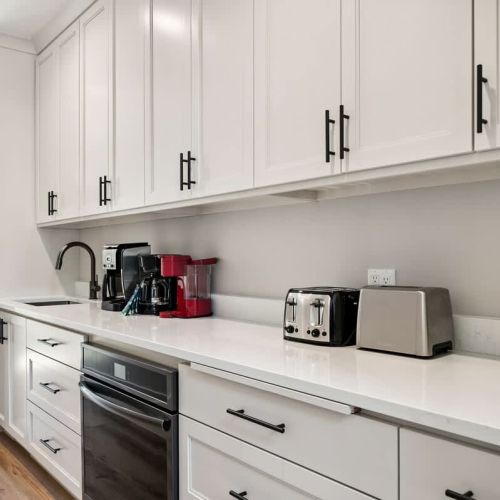 The butler's pantry acts as an additional food prep space, boasting a second fridge, oven, sink, and coffee bar.