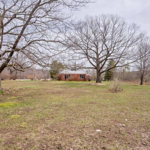 The large open yard offers space to run, play, and soak up the sun, while mature trees provide shade for relaxing from spring through fall.