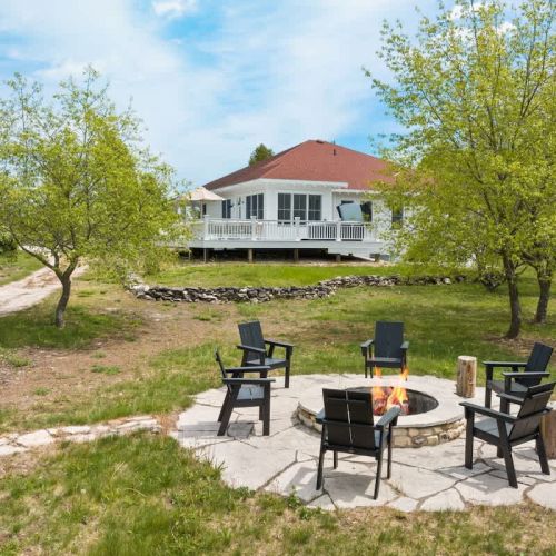 The fire pit invites you to gather around for s'mores and stories under the stars, while the hot tub provides a luxurious spot to unwind and soak in the tranquility of the dark sky region, ideal for stargazing and occasionally catching glimpses of th